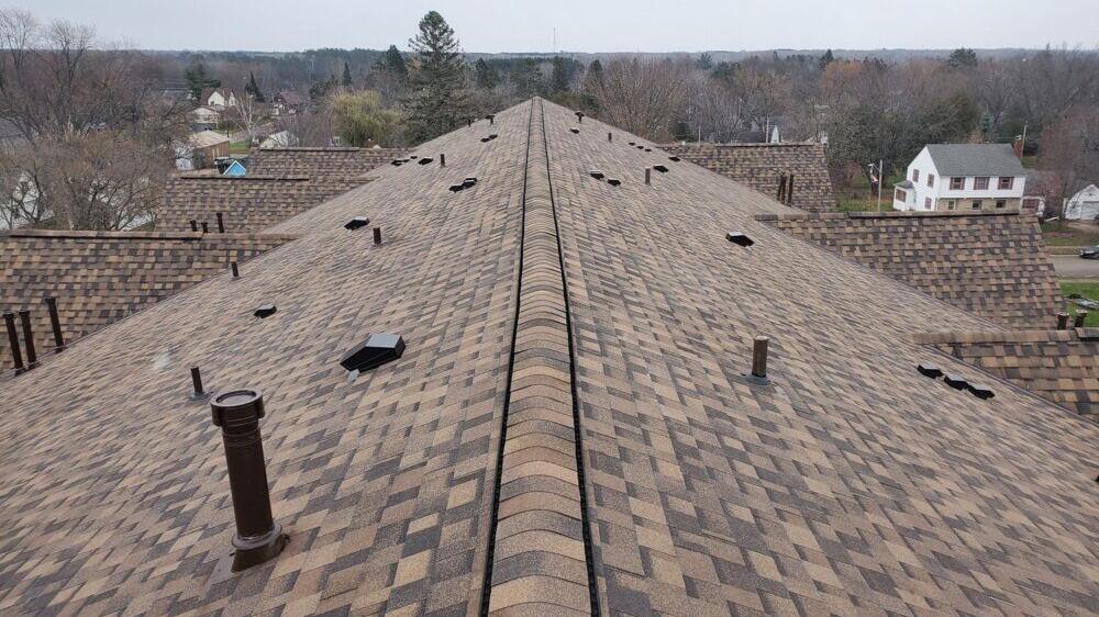 Asphalt shingle roof along the ridge of a home