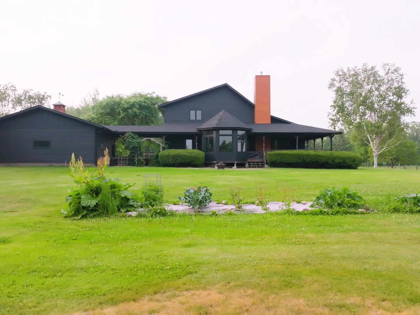 Residential home featuring new asphalt shingles, fiber cement siding, and bay window. | Omega Exteriors