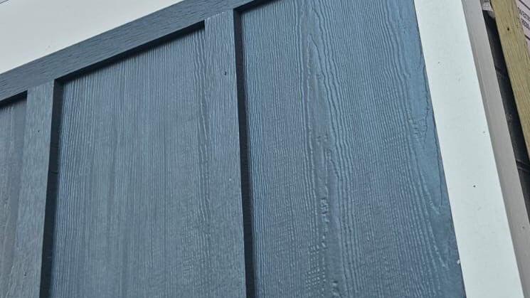 Gray board and batten siding with white trim
