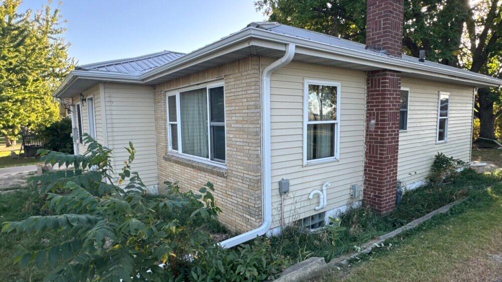 White seamless gutters and downspout on a home