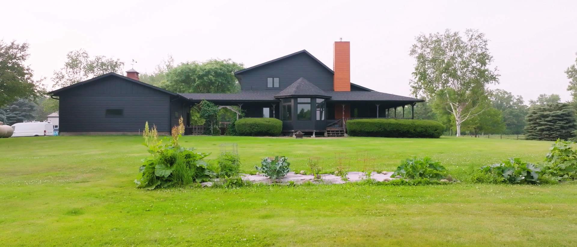 Residential home featuring new asphalt shingles, fiber cement siding, and bay window. | Omega Exteriors