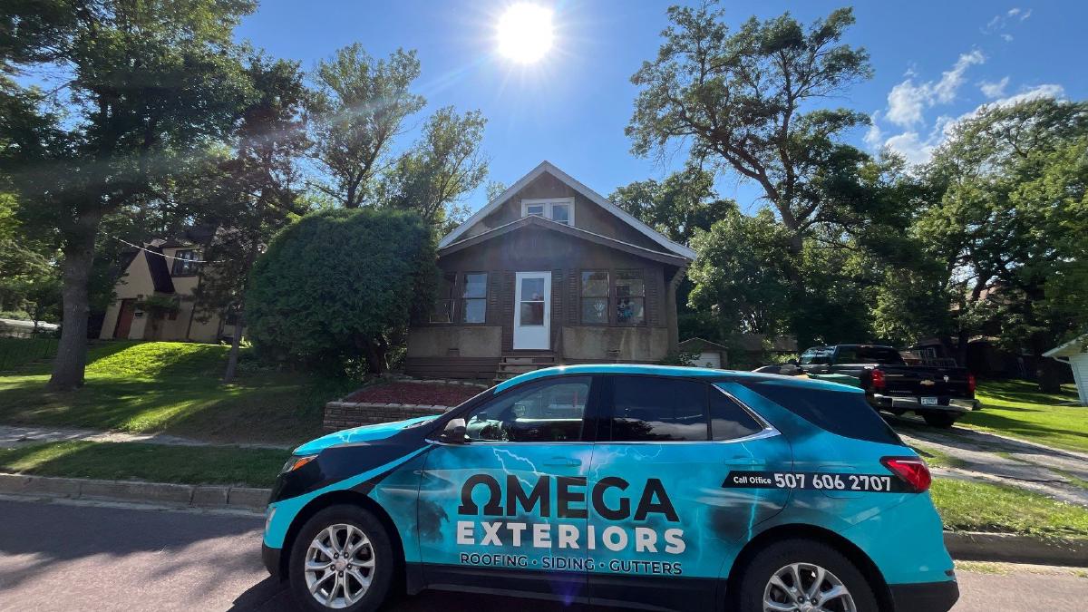 omega exteriors van parked in front of a finished home