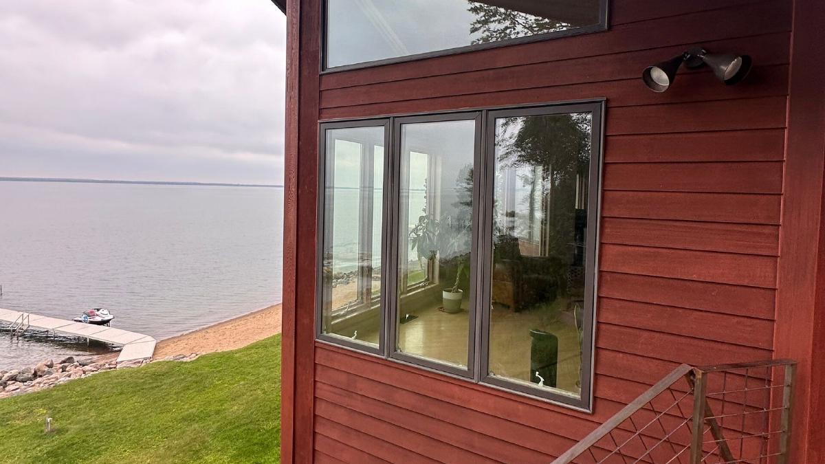 New corner windows on a red-sided lake home