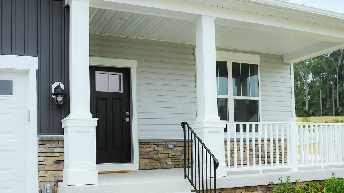 New white and gray siding on a home with a front porch