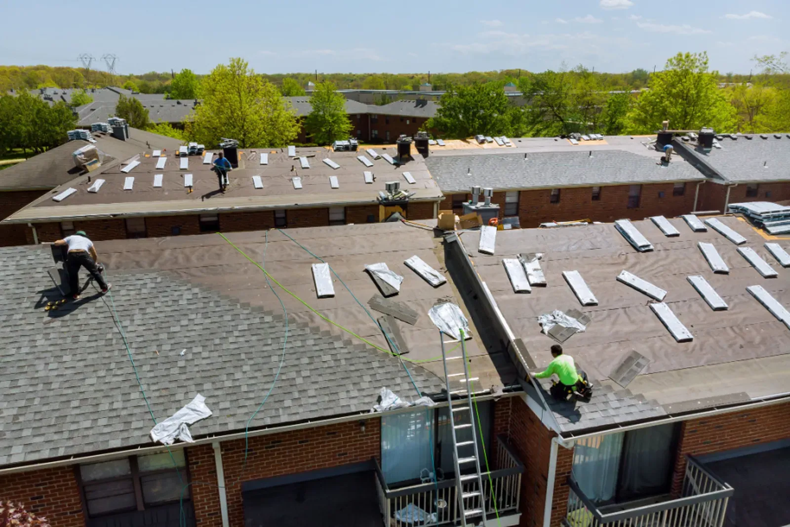 Installation of asphalt roofing on a multi-family building. | Omega Exteriors