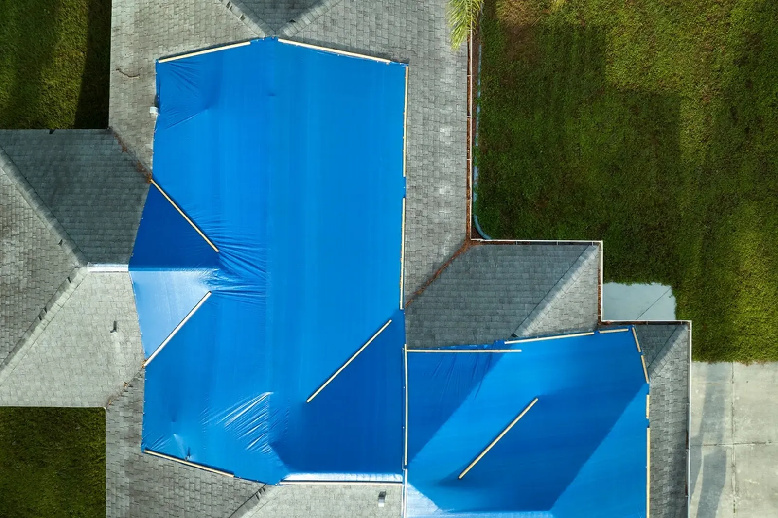An expert repairing a residential asphalt roof, showcasing hero-approved quality and craftsmanship. | Omega Exteriors
