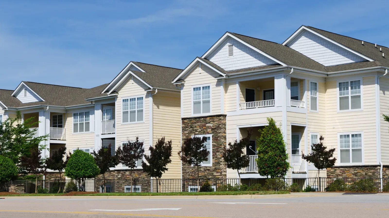 Image of a multi-family home having asphalt roof and vinyl siding installed. | Omega Exteriors