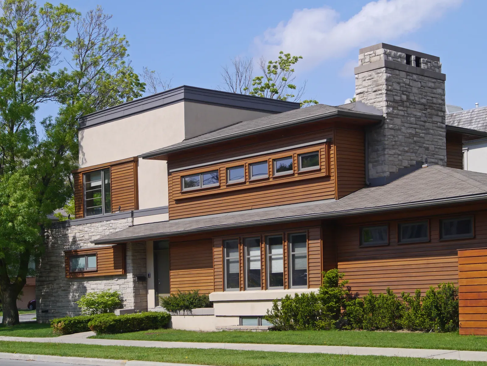 Cedar siding installation on a residential home, showcasing natural wood texture and color. | Omega Exteriors