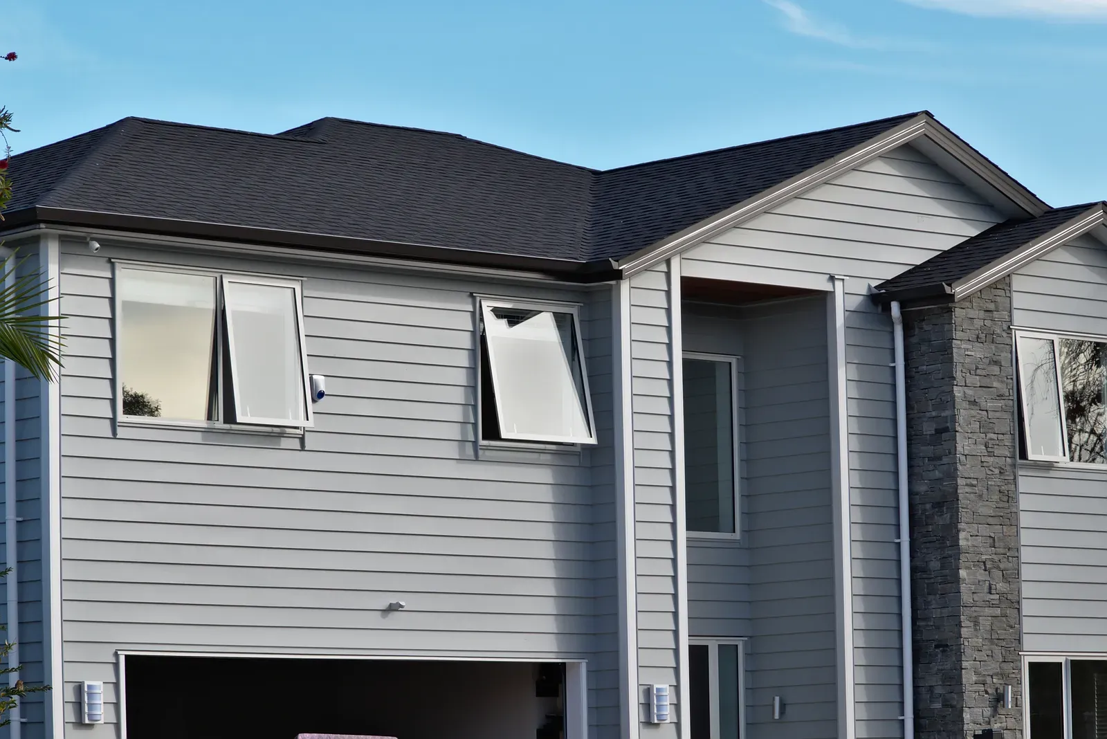 A professional repairing and installing residential awning windows. | Omega Exteriors