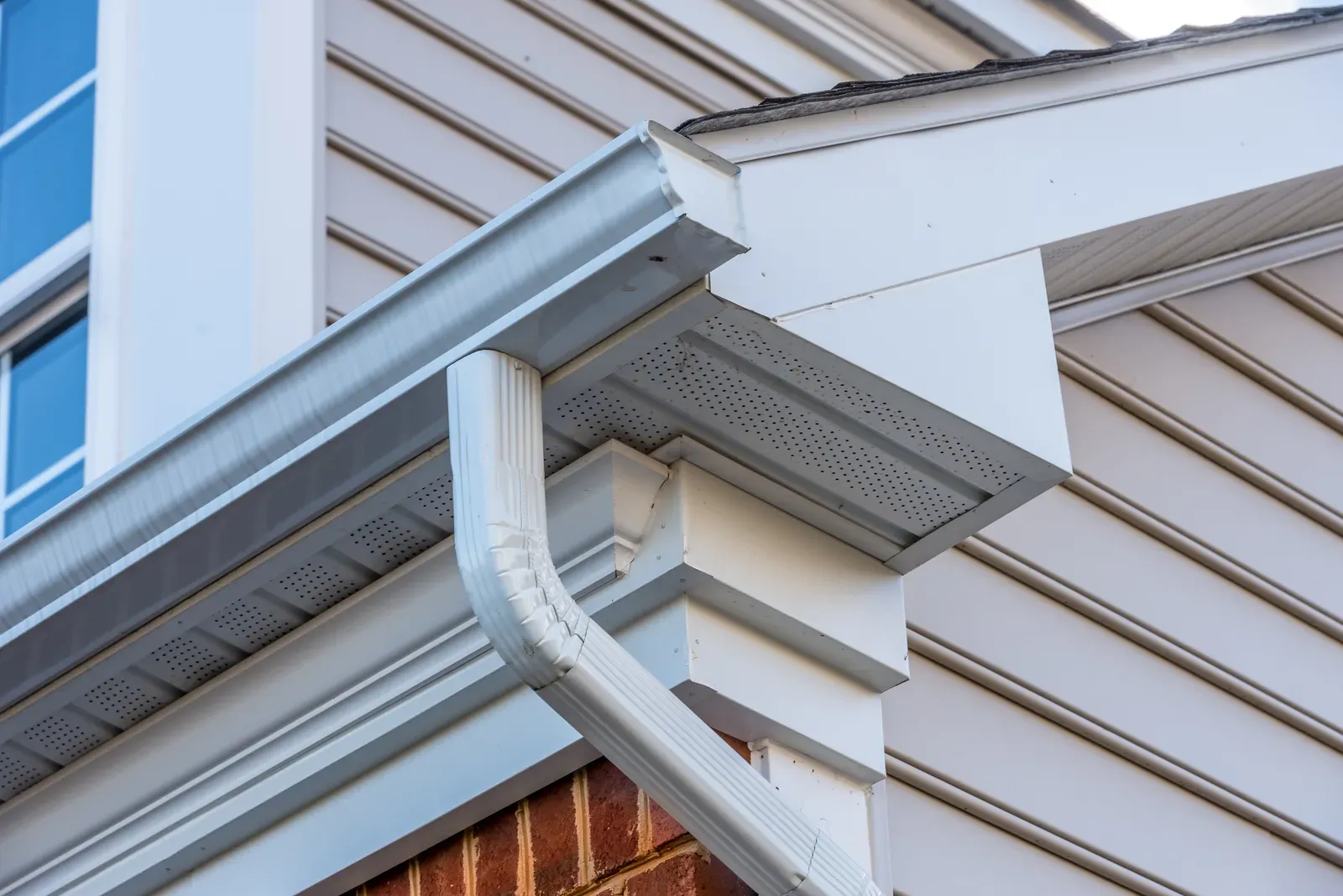 An aluminum gutter installation in a residential area, showcasing repair and replacement. | Omega Exteriors