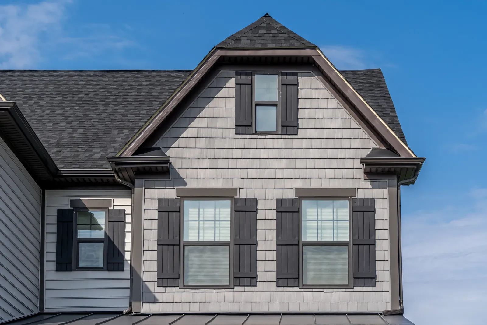 "Hero-approved residential siding installation and repair, featuring shake-style siding." | Omega Exteriors