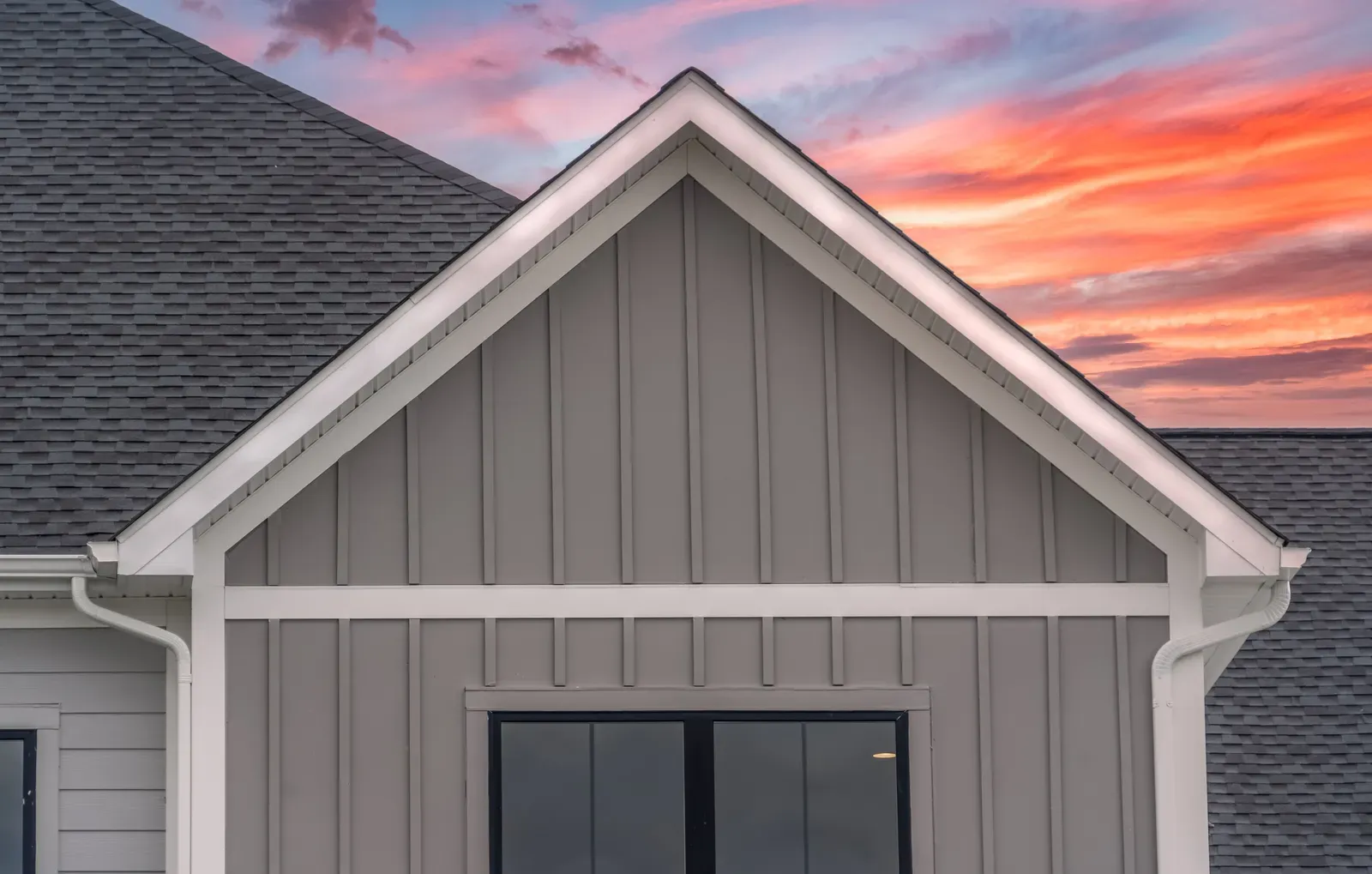 Image of a residential home showcasing new board-and-batten siding installation. | Omega Exteriors