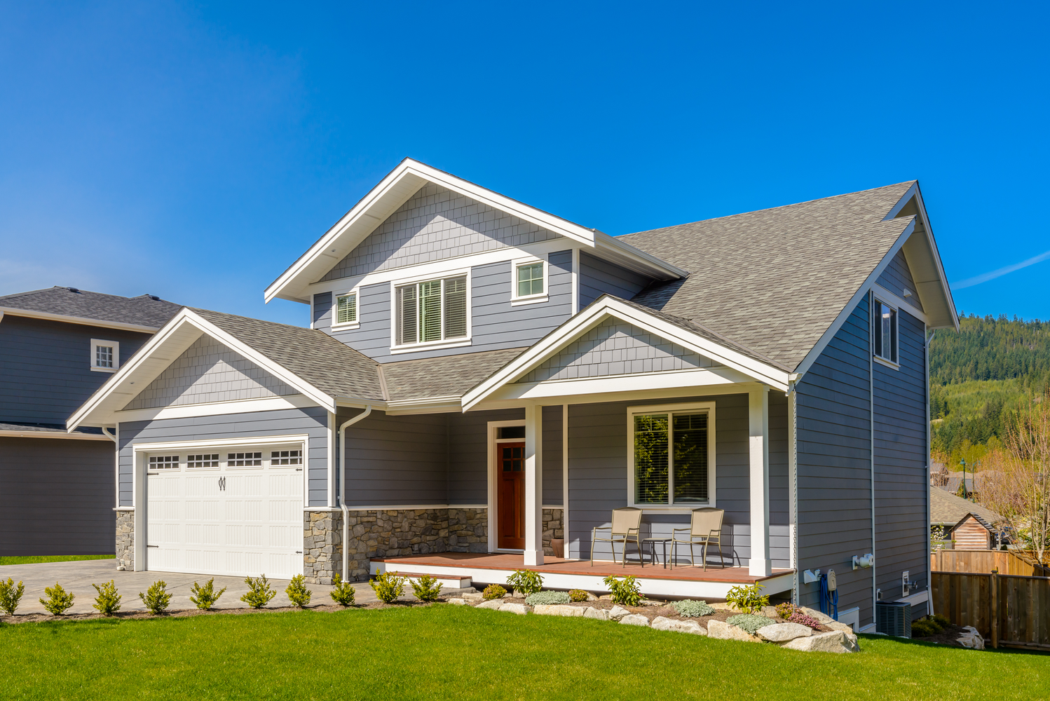 "Residential home featuring new asphalt roof, sliding windows, vinyl siding, and updated gutters." | Omega Exteriors