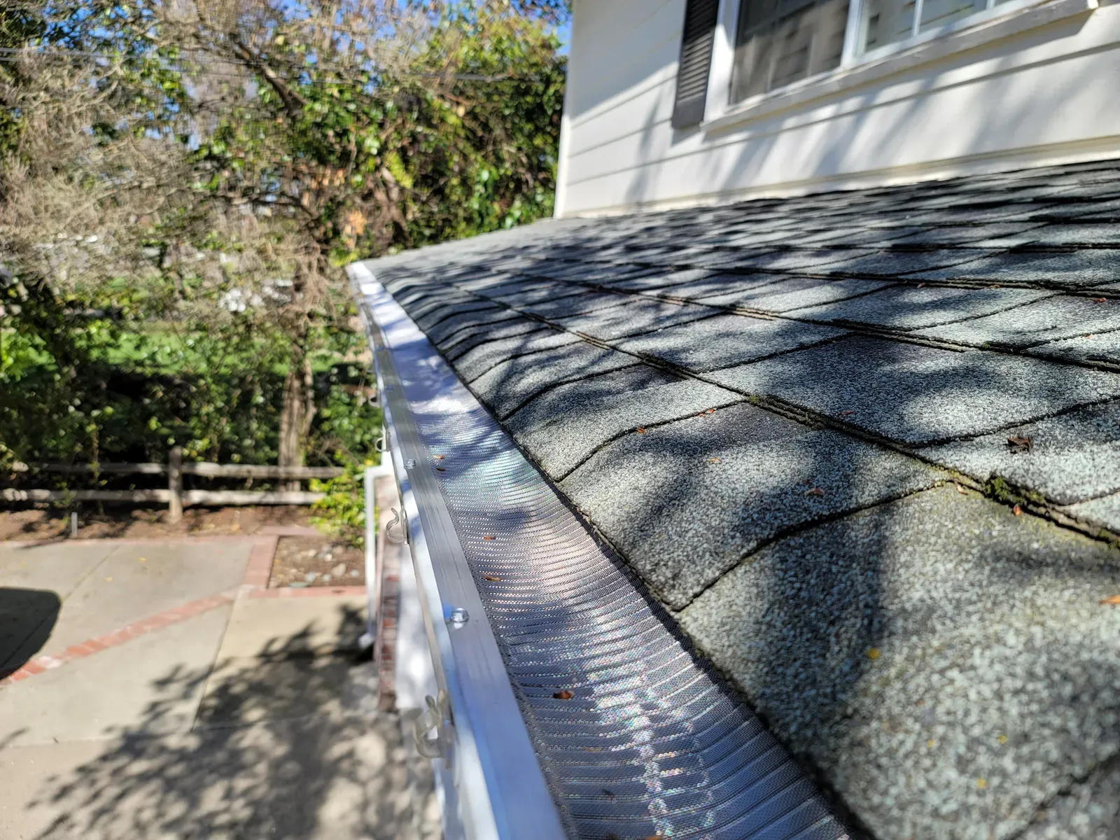Residential gutter installation and repair with guards for effective drainage. | Omega Exteriors