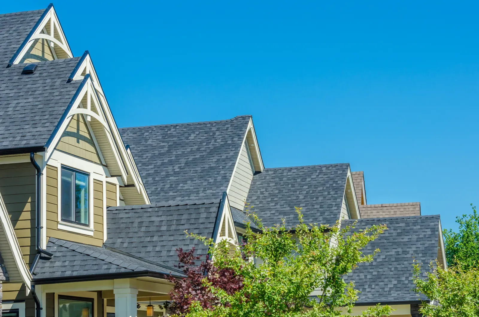 A newly replaced asphalt roof on a multi-family building, showcasing durability and style. | Omega Exteriors