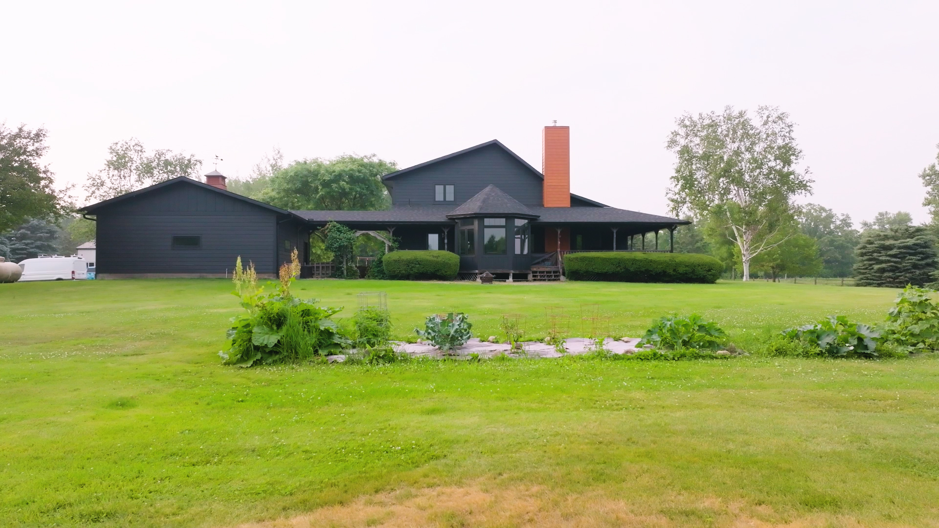 Residential home featuring new asphalt shingles, fiber cement siding, and bay window. | Omega Exteriors